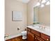 Powder room with wooden vanity, marble countertop, and gold fixtures at 1124 Clearspring Dr, Charleston, SC 29412