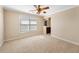 Bright bedroom with view to bathroom, featuring a ceiling fan and neutral walls at 1124 Clearspring Dr, Charleston, SC 29412