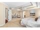 Bright bedroom with tray ceilings, sitting area, neutral walls, and access to ensuite bath at 1124 Clearspring Dr, Charleston, SC 29412