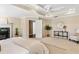 Bedroom featuring neutral walls, tray ceiling, access to ensuite bath and a cozy fireplace at 1124 Clearspring Dr, Charleston, SC 29412