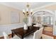 Elegant dining room with wooden table, chairs, chandelier, and view of the living area at 1124 Clearspring Dr, Charleston, SC 29412