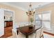 Charming dining room features a wooden table, upholstered chairs, and a decorative chandelier at 1124 Clearspring Dr, Charleston, SC 29412