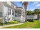 Home exterior featuring a screened porch, a deck, green grass and lush trees, complete with sidewalks at 1124 Clearspring Dr, Charleston, SC 29412
