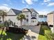 Beautiful house with black shutters and palm trees overlooking the calm waters of the lake at 1124 Clearspring Dr, Charleston, SC 29412