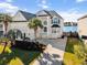 Charming waterfront home with lush landscaping, palm trees, and a private driveway at 1124 Clearspring Dr, Charleston, SC 29412