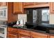 A sleek kitchen with black granite countertops, tile backsplash, and stainless steel appliances at 1124 Clearspring Dr, Charleston, SC 29412