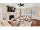 Bright and airy living room featuring a fireplace, hardwood floors, and custom seating at 1124 Clearspring Dr, Charleston, SC 29412