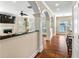 Bright living room with hardwood floors, arched doorways, fireplace, and bar seating area at 1124 Clearspring Dr, Charleston, SC 29412