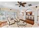 Bright living room with hardwood floors, lots of natural light, a ceiling fan, and an adjacent bar at 1124 Clearspring Dr, Charleston, SC 29412