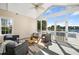 This screened porch boasts comfortable seating and serene lake views, perfect for relaxing outdoors at 1124 Clearspring Dr, Charleston, SC 29412