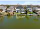 Waterfront backyard with dock and view of back of the house featuring a screened porch at 1124 Clearspring Dr, Charleston, SC 29412