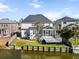 Rear exterior of home featuring screened porch and yard leading to waterfront at 1124 Clearspring Dr, Charleston, SC 29412