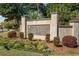 Stone monument sign at the entrance to Ocean Neighbors, surrounded by flowers and landscaping at 1124 Clearspring Dr, Charleston, SC 29412