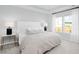 Bright bedroom with a large window, tray ceiling, neutral walls, and white comforter set at 114 Snow St, Summerville, SC 29486