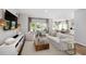 Bright open living room with modern decor flowing into a kitchen with light wood floors at 114 Snow St, Summerville, SC 29486