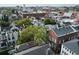 A Charleston neighborhood showing a mix of historic houses with a backdrop of lush trees at 12 Elliott St # A, Charleston, SC 29401