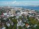 An aerial view showcases beautiful Charleston homes with waterfront views and the Ravenel Bridge in the distance at 12 Elliott St # A, Charleston, SC 29401