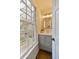 Charming bathroom with a gray vanity, bright lighting, and a window view of lush greenery at 12 Elliott St # A, Charleston, SC 29401