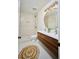 Modern bathroom features a double sink vanity, tiled shower, and round decorative mirror at 12 Elliott St # A, Charleston, SC 29401
