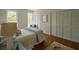 Inviting bedroom features two windows, louvred door closet, and a comfortable bed with a gray comforter at 12 Elliott St # A, Charleston, SC 29401