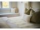 Bedroom with a window seat, comfy bed and decorative pillows at 12 Elliott St # A, Charleston, SC 29401
