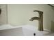 Close up of a brushed nickel faucet with a white sink at 12 Elliott St # A, Charleston, SC 29401