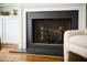 Close-up of a classic fireplace with black trim and brass accents at 12 Elliott St # A, Charleston, SC 29401