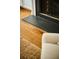 Elegant fireplace detail with hardwood flooring and a cozy area rug at 12 Elliott St # A, Charleston, SC 29401