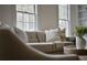 Bright living room with comfortable seating and natural light streaming through large windows at 12 Elliott St # A, Charleston, SC 29401