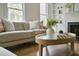 Inviting living area with neutral tones, plush sofa, and a round coffee table, perfect for relaxation at 12 Elliott St # A, Charleston, SC 29401
