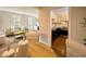 Bright living room with hardwood floors, neutral walls, large windows, and a view into the kitchen at 12 Elliott St # A, Charleston, SC 29401
