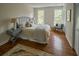 Relaxing bedroom featuring hardwood floors, light-filled windows, and a cozy reading corner at 12 Elliott St # A, Charleston, SC 29401