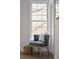Sunlit reading nook with a cozy armchair, bright window, and ample natural light at 12 Elliott St # A, Charleston, SC 29401