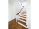 Elegant staircase with white risers, wooden treads, and a classic banister, showcasing the home's architectural detail at 12 Elliott St # A, Charleston, SC 29401