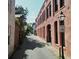 Charming street view with historic architecture, a pink building, and tree-lined street at 12 Elliott St # A, Charleston, SC 29401