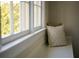 Close up of a window seat with pillows in a bedroom at 12 Elliott St # A, Charleston, SC 29401