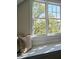 Close up of window seat with pillows and natural sunlight in a bedroom at 12 Elliott St # A, Charleston, SC 29401