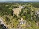 Wide aerial view of the property showcasing the home, outbuilding, and surrounding wooded area at 1212 Pinopolis Rd, Moncks Corner, SC 29461