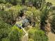 Aerial view of home, outbuilding, and firepit surrounded by mature trees on a large lot at 1212 Pinopolis Rd, Moncks Corner, SC 29461