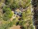 Bird's eye view of the home and outbuilding on a wooded lot, highlighting the property's setting at 1212 Pinopolis Rd, Moncks Corner, SC 29461