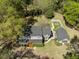Aerial view of home and outbuilding, showcasing large yard with firepit and surrounding mature trees at 1212 Pinopolis Rd, Moncks Corner, SC 29461