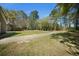 Expansive backyard with a well-maintained lawn and lush trees at 1212 Pinopolis Rd, Moncks Corner, SC 29461
