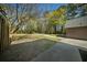 Spacious backyard featuring mature trees and a concrete patio, perfect for outdoor entertaining at 1212 Pinopolis Rd, Moncks Corner, SC 29461