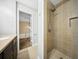 A bathroom featuring a modern tiled shower with a view to the sink and vanity at 1212 Pinopolis Rd, Moncks Corner, SC 29461