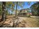 Exterior of a charming home featuring a wraparound porch, perfect for enjoying the serene surroundings at 1212 Pinopolis Rd, Moncks Corner, SC 29461