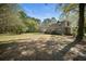 Two-story home with an outbuilding situated on a large lot with mature trees at 1212 Pinopolis Rd, Moncks Corner, SC 29461