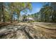 Exterior shot of a home with a large yard, surrounded by mature trees offering ample privacy at 1212 Pinopolis Rd, Moncks Corner, SC 29461