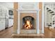Traditional fireplace with brick surround, white mantle and a view to the kitchen at 1212 Pinopolis Rd, Moncks Corner, SC 29461