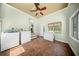 Well-lit laundry room featuring brick flooring, a washing machine, dryer, and a chest freezer at 1212 Pinopolis Rd, Moncks Corner, SC 29461