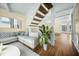 Bright living room with hardwood floors, a staircase, and a comfortable sectional sofa at 1212 Pinopolis Rd, Moncks Corner, SC 29461